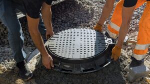 Two professionals install a new septic system.